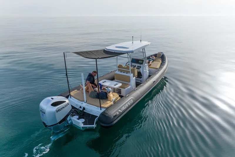 Slide: The Image of 2026 Highfield Sport 800 boat on calm water, featuring Honda engine. - 6