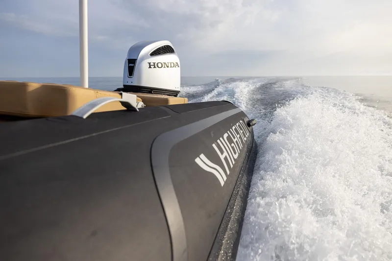Slide: The Image of Highfield Sport 800 boat with Honda engine cruising on open water, 2026 model. - 9