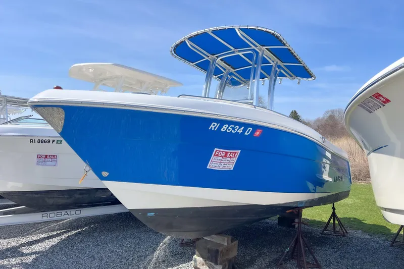 The Image of 2018 Robalo R222 Explorer boat for sale, blue hull, parked on stands. - 0