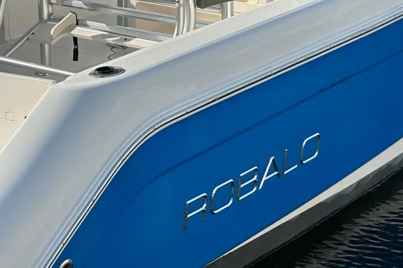 Slide: The Image of 2018 Robalo R222 Explorer boat with blue and white exterior detailing. - 4