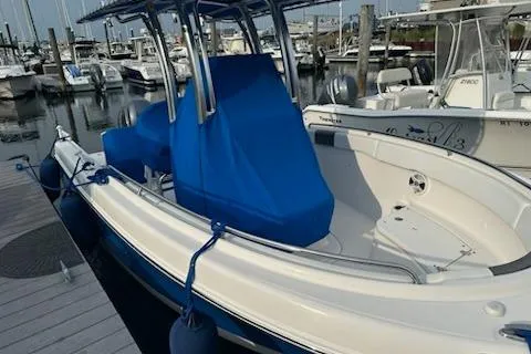 Slide: The Image of 2018 Robalo R222 Explorer boat docked at marina with blue cover. - 6