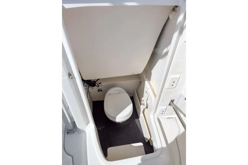Slide: The Image of 2018 Robalo R222 Explorer boat interior with compact marine toilet. - 8