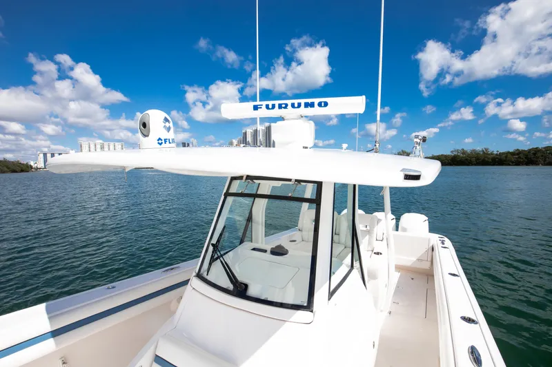 Slide: The Image of 2017 Intrepid 375 Center Console boat on calm water under a clear blue sky. - 11