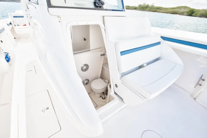 Slide: The Image of 2017 Intrepid 375 Center Console boat interior with open bathroom compartment. - 13