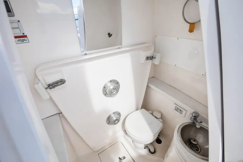 Slide: The Image of 2017 Intrepid 375 Center Console boat bathroom with toilet and sink. - 14