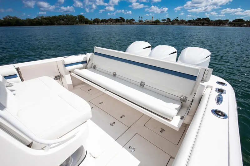 Slide: The Image of 2017 Intrepid 375 Center Console boat with seating and triple engines on calm water. - 18