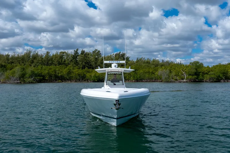 Slide: The Image of 2017 Intrepid 375 Center Console boat on calm water with cloudy sky backdrop. - 24