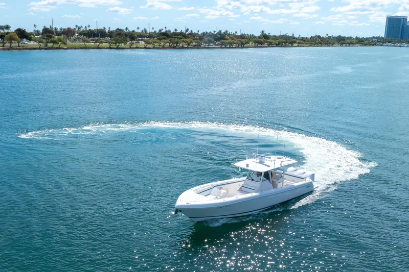 Slide: The Image of 2017 Intrepid 375 Center Console boat cruising on clear blue water. - 4