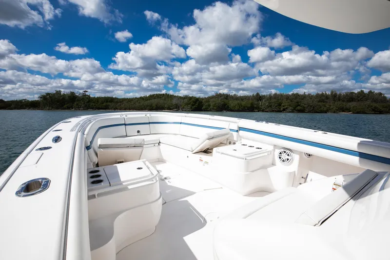 Slide: The Image of 2017 Intrepid 375 Center Console boat with spacious seating, under a vibrant blue sky. - 7