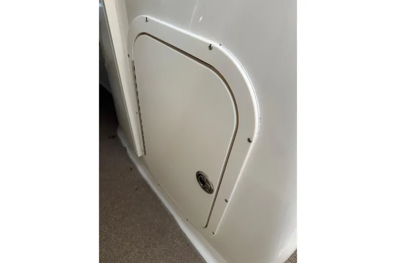 Slide: The Image of Storage compartment door on a 2005 Chaparral Sunesta 236 boat interior. - 4