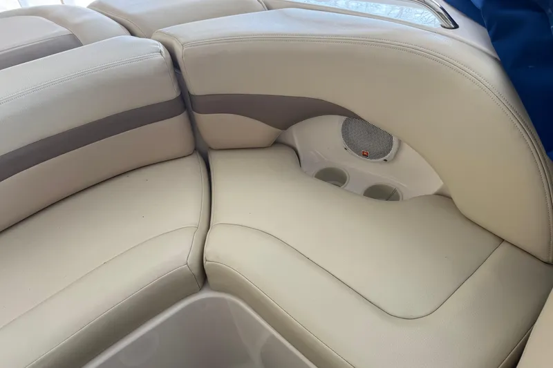 Slide: The Image of 2005 Chaparral Sunesta 236 boat interior with beige seating and built-in speaker. - 6