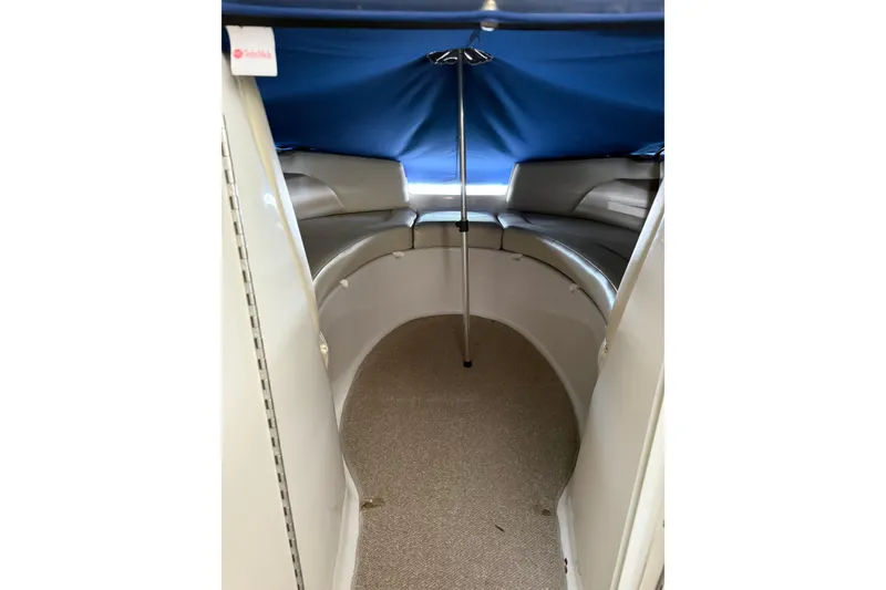 Slide: The Image of Interior of 2005 Chaparral Sunesta 236 boat with blue canopy and seating area. - 7