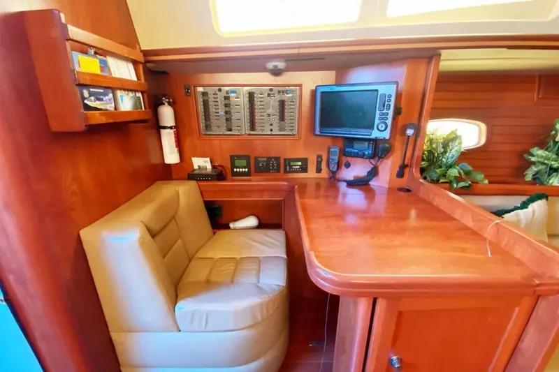 Slide: The Image of Luxurious 2012 Hunter Aft Cockpit 50 yacht interior with navigation station and plush seating. - 10