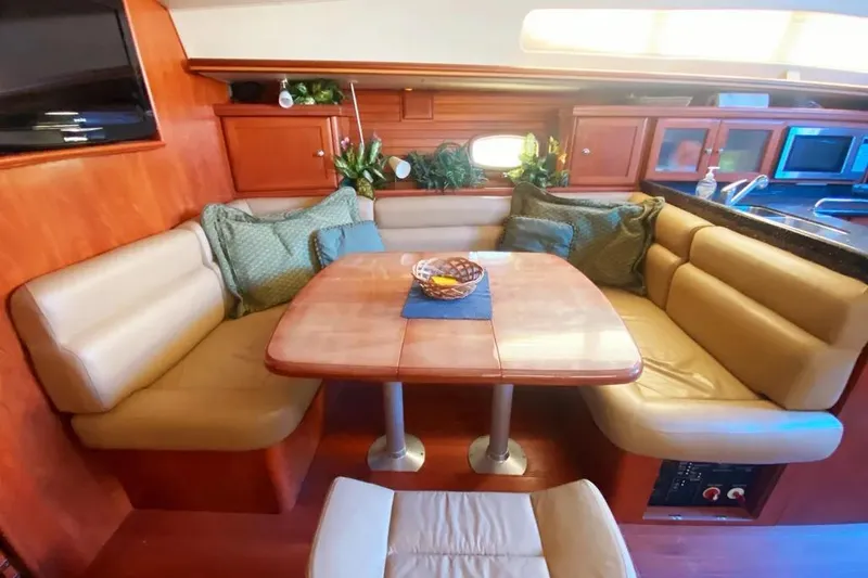 Slide: The Image of Luxurious interior of 2012 Hunter Aft Cockpit 50 yacht with cozy seating and dining area. - 12