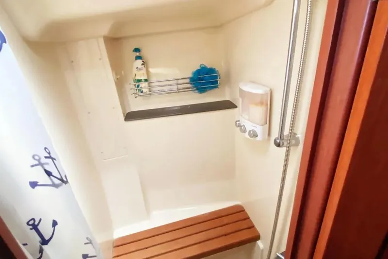 Slide: The Image of Shower area in 2012 Hunter Aft Cockpit 50 yacht with wooden bench and nautical curtain. - 14