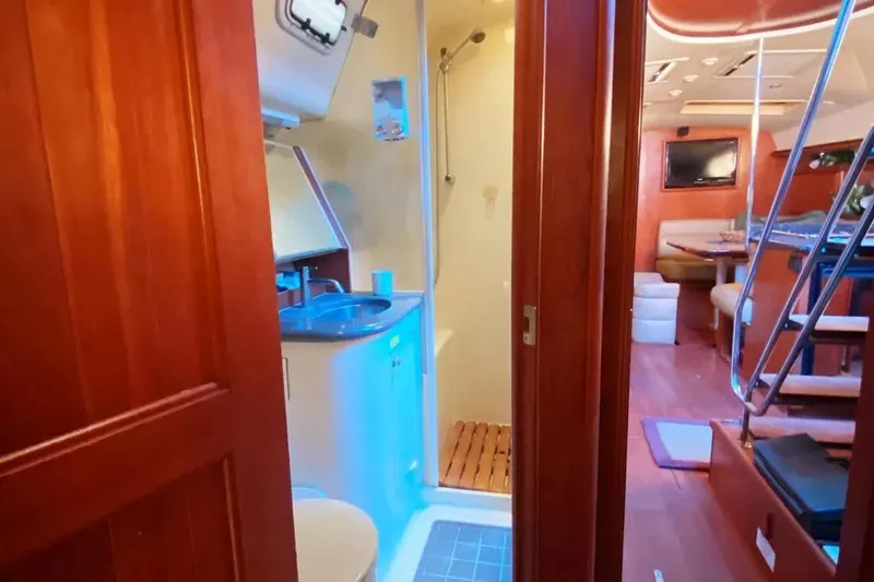Slide: The Image of Interior of 2012 Hunter Aft Cockpit 50 yacht, featuring bathroom and living area. - 15