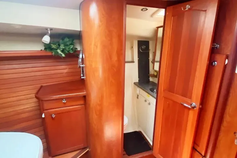 Slide: The Image of Interior of 2012 Hunter Aft Cockpit 50 yacht with wooden cabinetry and bathroom. - 21
