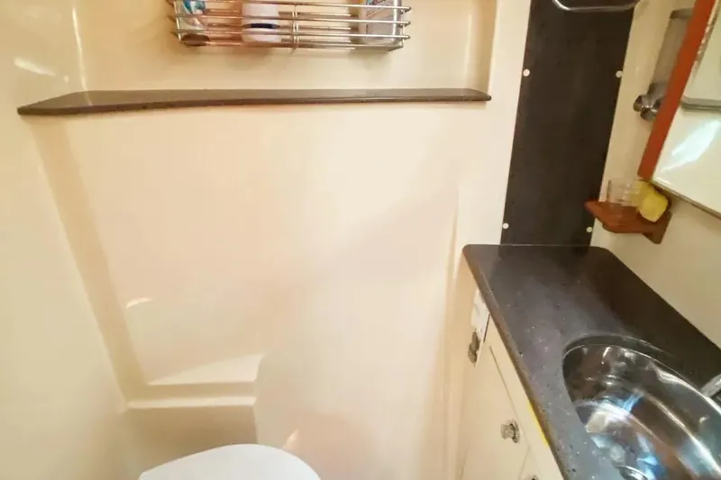 Slide: The Image of Compact bathroom in 2012 Hunter Aft Cockpit 50 yacht with sink and storage. - 22