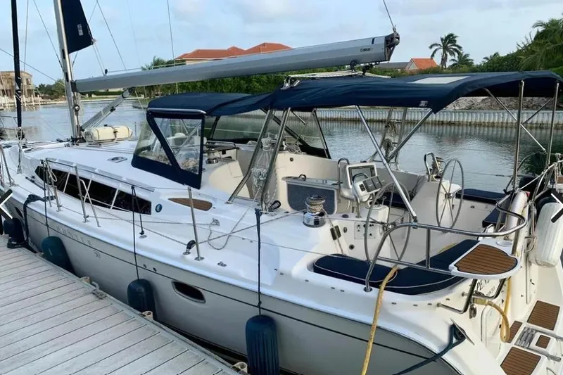 Slide: The Image of Hunter Aft Cockpit 50 sailboat, 2012 model, docked by a serene waterfront. - 29