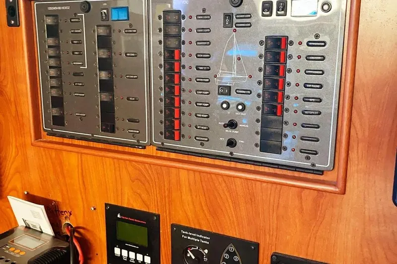 Slide: The Image of Control panel of a 2012 Hunter Aft Cockpit 50 yacht with various switches and indicators. - 34