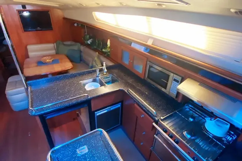 Slide: The Image of Luxurious interior of 2012 Hunter Aft Cockpit 50 yacht with modern kitchen and seating area. - 6
