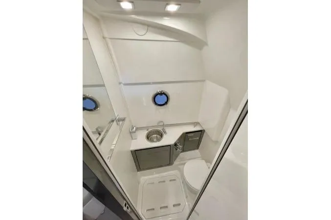 Slide: The Image of Compact bathroom in 2027 Schaefer V34 yacht with modern fixtures and porthole window. - 10