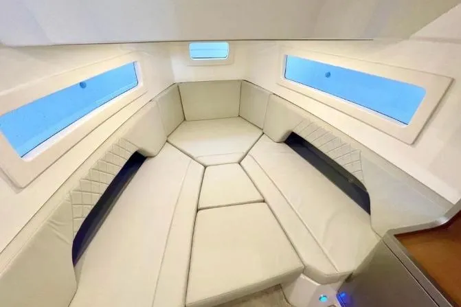 Slide: The Image of Luxurious interior of 2027 Schaefer V34 yacht with elegant white seating and large windows. - 13