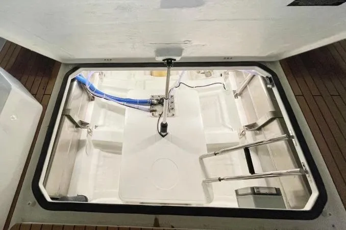 Slide: The Image of Open hatch of 2027 Schaefer V34 boat showing interior storage compartment. - 7