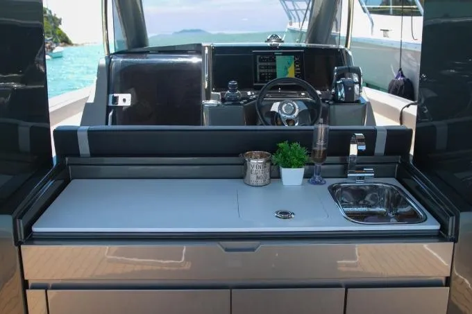 Slide: The Image of Modern Schaefer V34 yacht interior with sleek kitchen and steering area, 2027 model. - 9