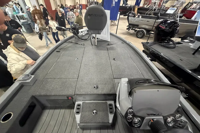 Slide: The Image of 2026 Vexus AVX 1985s boat interior at a crowded exhibition, showcasing deck and controls. - 5