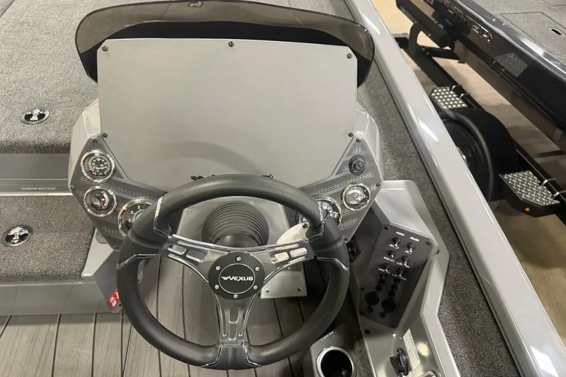 Slide: The Image of 2026 Vexus AVX 1985s boat dashboard with steering wheel and control panel. - 7