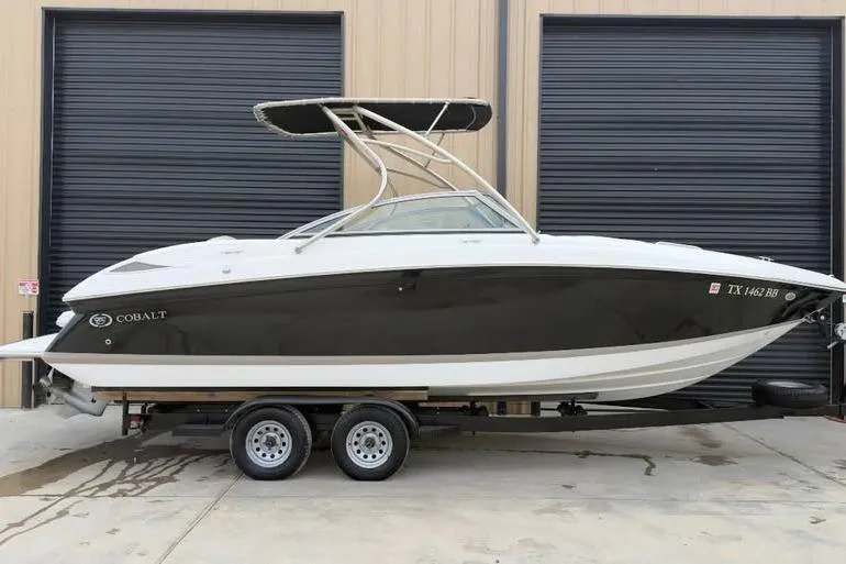 Slide: The Image of 2010 Cobalt 242 boat on trailer, parked in front of garage doors. - 6