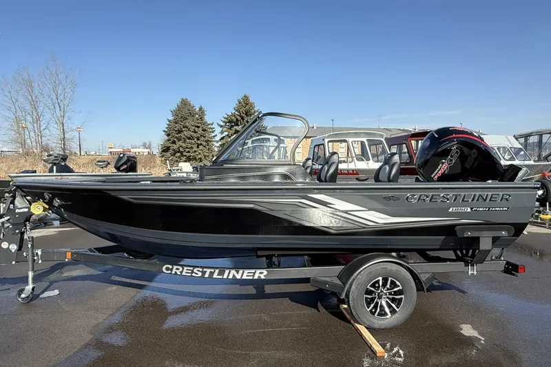 The Image of 2026 Crestliner 1850 Fish Hawk WT boat on trailer, parked outdoors. - 0