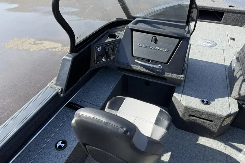 Slide: The Image of 2026 Crestliner 1850 Fish Hawk WT boat interior with seating and storage compartments. - 10