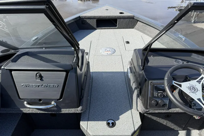 Slide: The Image of 2026 Crestliner 1850 Fish Hawk WT boat interior with steering wheel and storage compartments. - 11