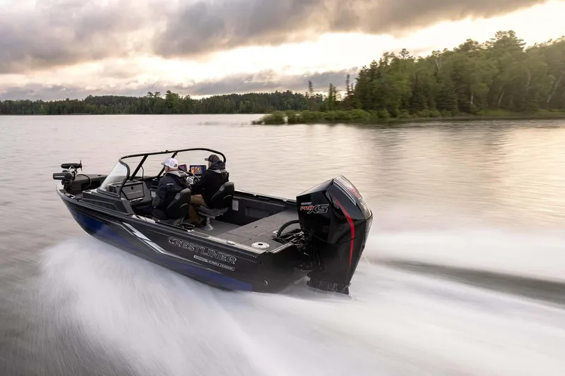 Slide: The Image of 2026 Crestliner 1850 Fish Hawk WT speeding on a serene lake at sunset. - 21