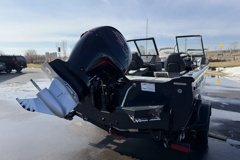 Slide: The Image of 2026 Crestliner 1850 Fish Hawk WT boat with powerful outboard motor, parked outdoors. - 5