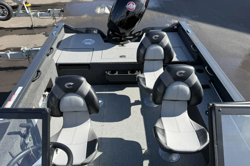 Slide: The Image of 2026 Crestliner 1850 Fish Hawk WT interior with four seats and motor, ideal for fishing. - 6