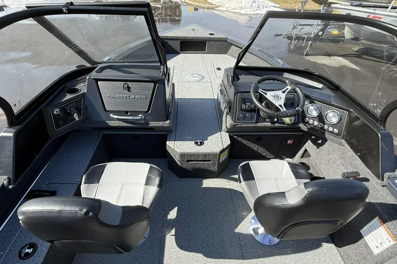 Slide: The Image of 2026 Crestliner 1850 Fish Hawk WT boat interior with dual seats and steering console. - 7
