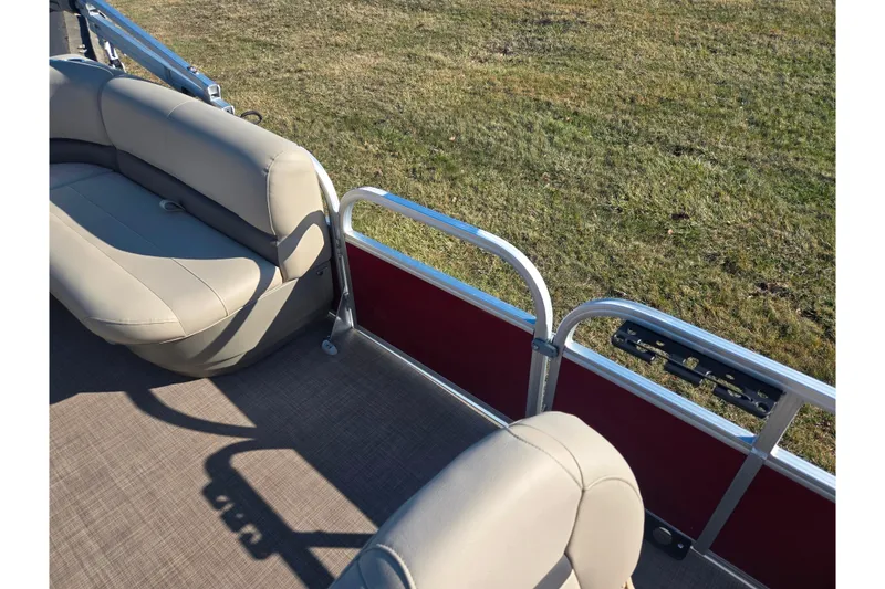Slide: The Image of 2024 Sun Tracker Bass Buggy 16 XL Select interior with beige seating and red paneling. - 11