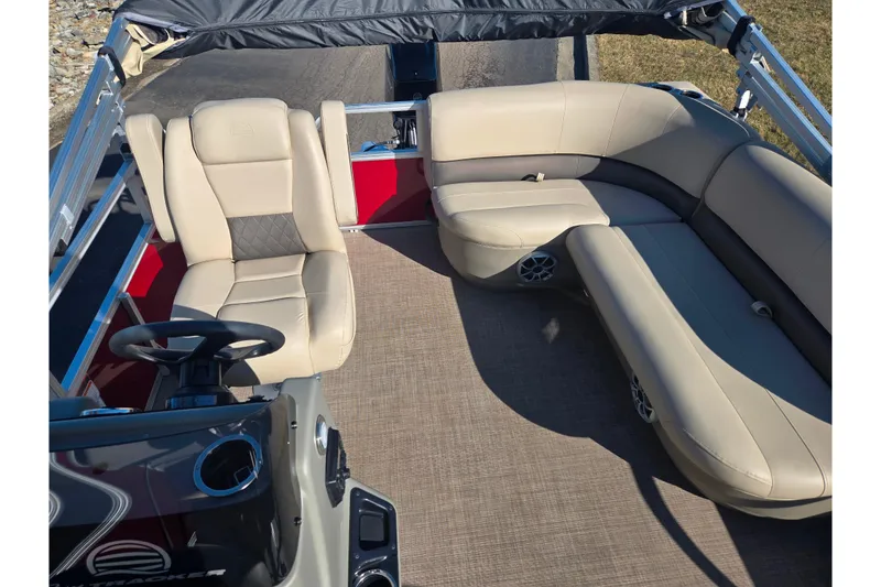 Slide: The Image of 2024 Sun Tracker Bass Buggy 16 XL Select interior with beige seating and steering console. - 14