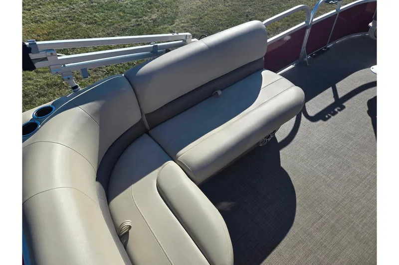 Slide: The Image of 2024 Sun Tracker Bass Buggy 16 XL Select pontoon boat with beige seating and cup holders. - 17