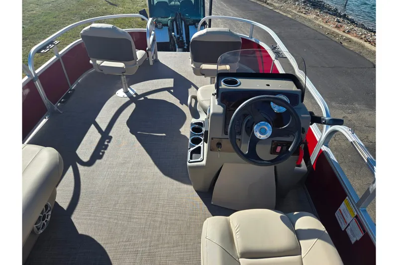 Slide: The Image of 2024 Sun Tracker Bass Buggy 16 XL Select pontoon boat interior with steering console and seating. - 18