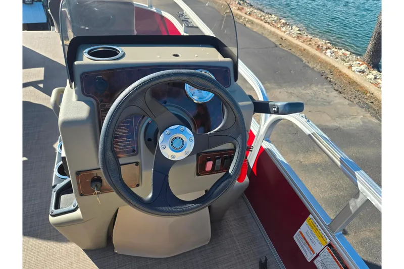 Slide: The Image of 2024 Sun Tracker Bass Buggy 16 XL Select steering console by the water. - 19