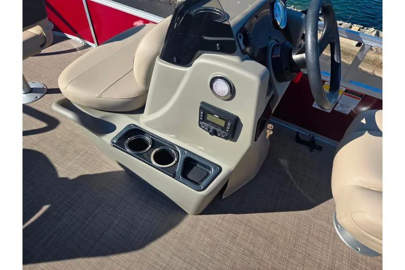 Slide: The Image of 2024 Sun Tracker Bass Buggy 16 XL Select console with steering wheel and cup holders. - 20