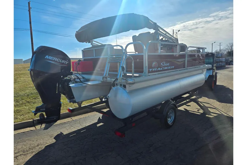 Slide: The Image of 2024 Sun Tracker Bass Buggy 16 XL Select pontoon boat with Mercury engine on trailer. - 3