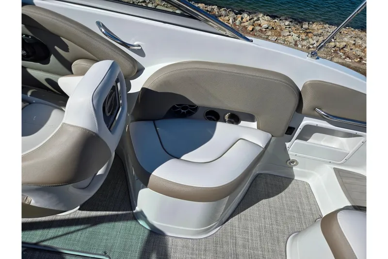 Slide: The Image of 2020 Crownline Eclipse E235 boat interior with beige seating and cup holders. - 13
