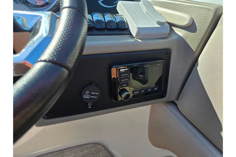 Slide: The Image of 2020 Crownline Eclipse E235 dashboard with audio system and steering wheel detail. - 20