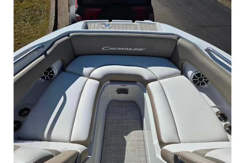 Slide: The Image of 2020 Crownline Eclipse E235 boat interior with cushioned seating and cup holders. - 21