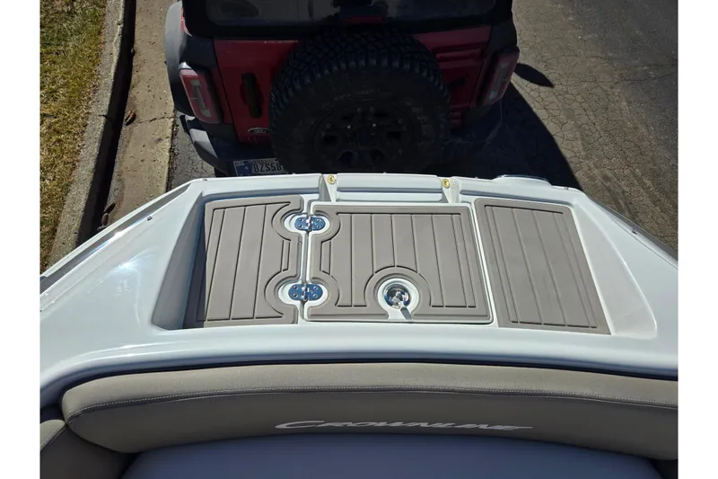 Slide: The Image of 2020 Crownline Eclipse E235 boat with rear deck and vehicle in background. - 22